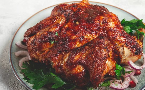 Whole fried chicken, with spices, grilled chicken, on a light background, top view, homemade, no