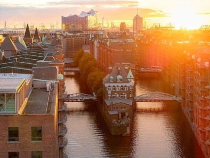 Aerial view of Speicherstadt Hamburg with Fleetschlösschen and Elbe Philharmonic Hall at sunset,