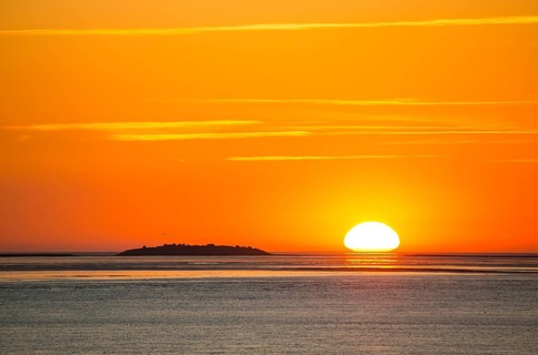 Picturesque, golden, magnificently beautiful sunset over the sea, Langlütjen II island far away,