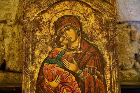Icon with Mary and baby Jesus against a brick background, gilded accents, Monastery of Our Lady of