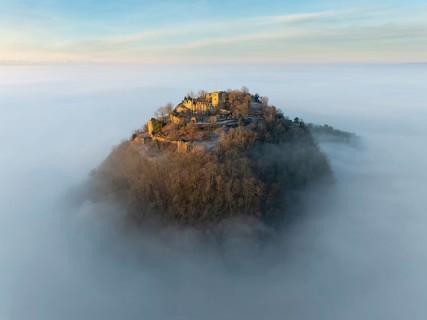 Aerial view of the Hegau volcano Hohentwiel with the upper fortress ruins illuminated by the rising