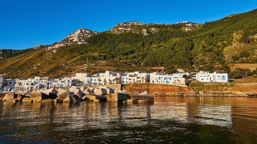 Concrete breakwater, White houses, Wooded hillside, Mountain, Morning light, Marettimo village,