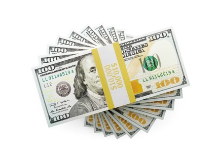 Overhead of one hundred thousand dollars spiralling stacks of one hundred dollar bills isolated on