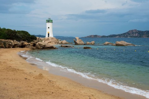 Lighthouse with beach and bizarre granite rocks, Spiaggia Porto Faro, Faro di Punta Palau, Palau,