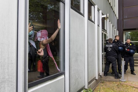 Activists try to entrench themselves inside the university during the occupation of the courtyard