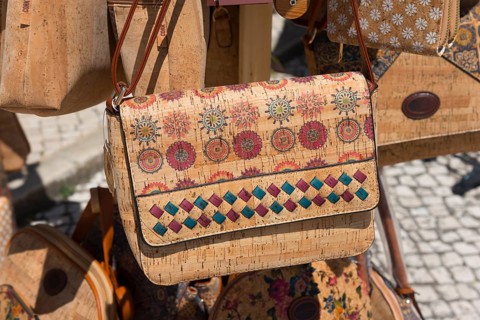 Close-up of a handbag with detailed pattern and bright colours, showing handicraft work at a