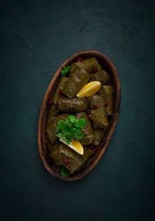 Dolma (Tolma) stuffed rolls, minced meat with rice, in grape leaves, top view, no people, close-up