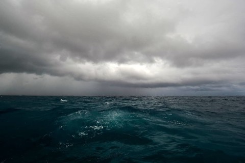 Tropical storm Growing typhoon due to climate change Storm with dark clouds over agitated sea,