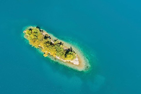 Bird's eye view of the chive island in the turquoise waters of Lake Walen in the canton of St.