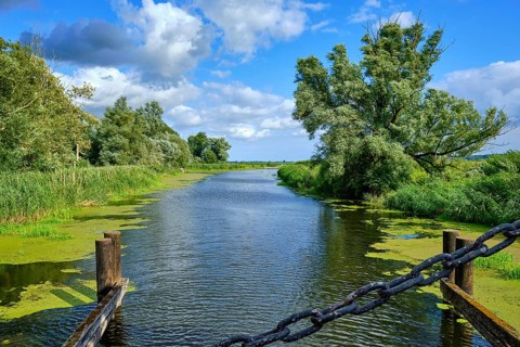 Picturesque river landscape, view from the heritage-protected wooden bascule bridge over the Trebel