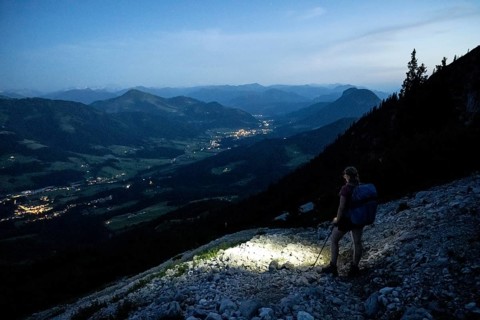 Female mountaineer hiking at night with a torch, Kaisergebirge, Wilder Kaiser, Kitzbühel Alps,