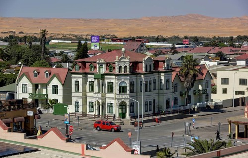 Hohenzollernhaus from 1906, neo-baroque, in the background dunes of the Namib desert, Swakopmund,
