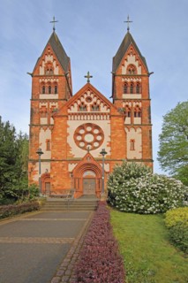 Neo-Romanesque St Lutwinus Church with twin towers and rose window, Mettlach, Saarland, Germany,