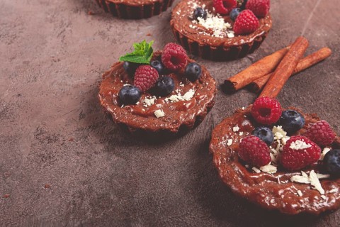 Chocolate tartlets, stuffed with cottage cheese and berries, breakfast, homemade, no people