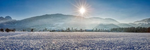 Wide wintry panorama with snow, sunny mountains and clear sky, Bad Feilnbach