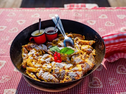 Kaiserschmarrn with decoration in a rustic pan on a tablecloth, South Tyrol, Italy, Europe