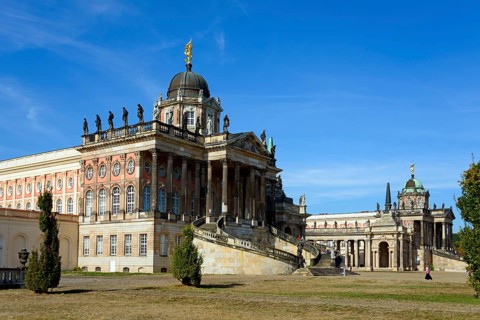 An imposing baroque palace on a sunny day with a blue sky and few clouds, The Communs, Sanssouci