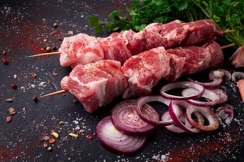Raw pork meat, pickled kebab, with spices, top view, no people