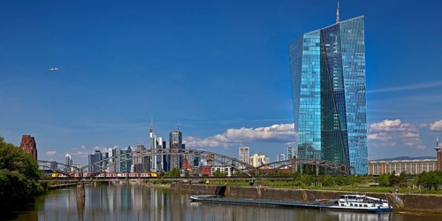 ECB European Central Bank with cargo ship on the river Main and the skyline of Frankfurt am Main,