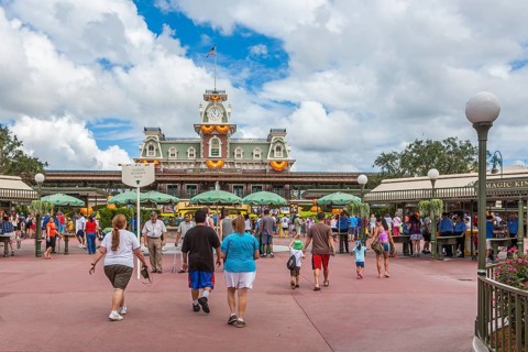 Park visitors walking into the Magic Kingdom at Walt Disney World, Florida, USA, North America