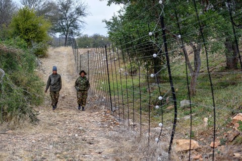 Rangers from the Black Mambas Anti-Poacher Unit patrolling the game fence, Balule Game Reserve,