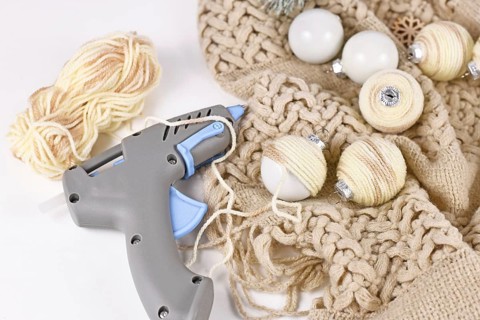 DIY boho style Christmas bauble ornaments with with cream colored cord attached to balls with hot