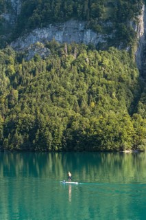 Stand-up paddler on Lake Klöntal, Canton Glarus, Switzerland, Europe