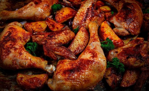 Roast chicken legs with potatoes and onions in the oven, homemade. No people