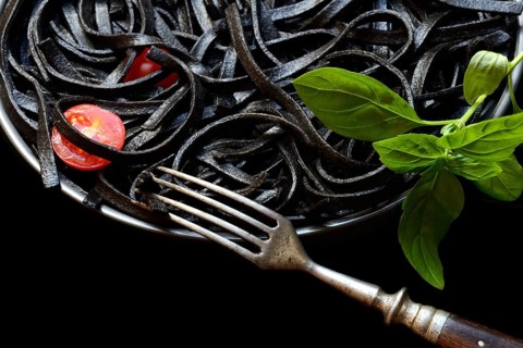 Black pasta coloured with squid ink on a plate, Taglioni al Nero di Seppia, Italy, Europe