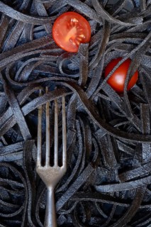 Black pasta coloured with squid ink and fork, Taglioni al Nero di Seppia, Italy, Europe