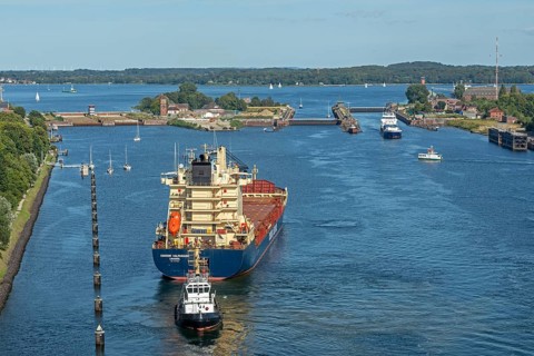 Cargo ship waiting in front of the lock, tugboat, Kiel Canal, Holtenau, Kiel, Schleswig-Holstein,