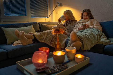 Symbolic image energy saving, cold winter, energy crisis, cold flat, mother and daughter lying on