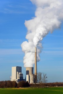 Large industrial plant with smoking chimney under a blue sky, coal-fired power plant, coal-fired