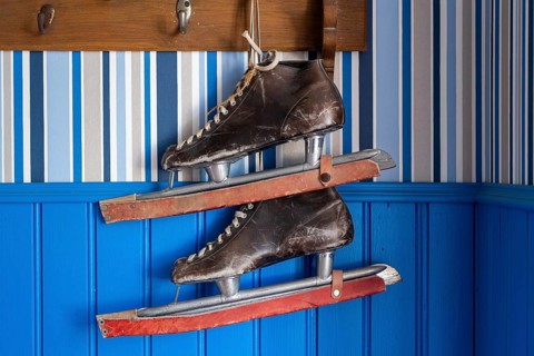 Old leather skates on a blue wall, Naantali or Nådendal, Baltic Sea coast, Finland, Europe