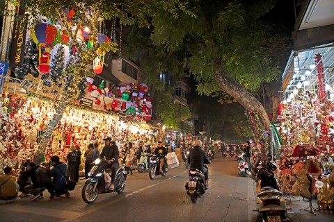 Mopeds driving through Hang Ma Christmas Lane in the old town of Hanoi, night shot, Vietnam, Asia
