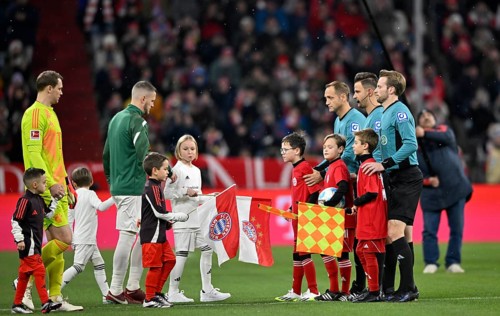 Ball kids, line up in front of kick-off of a Bundesliga match, referee team around referee Daniel