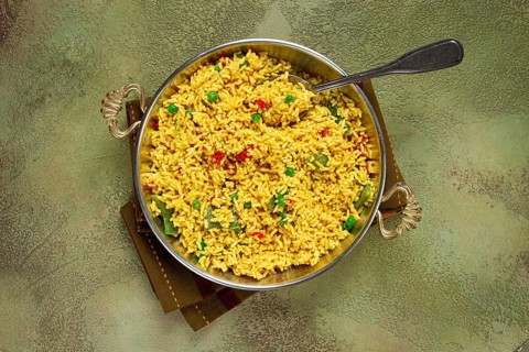 Rice with saffron and vegetables, in a frying pan, top view, homemade, no people