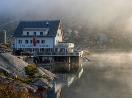 Sunrise on a foggy morning, hotel Grimsel mountain pass at lake Totensee, Switzerland, Europe