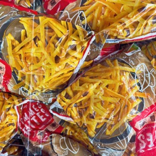 Display of deep-frozen French fries in freezer cabinet with transparent lid of supermarket,