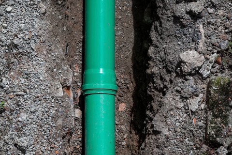 Newly laid green sewage pipe in a trench, Stuttgart, Baden-Württemberg
