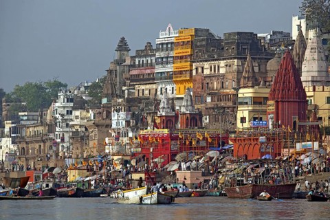 Holy city and colourful rowing boats on the Ganges river at Varanasi, Uttar Pradesh, India, Asia