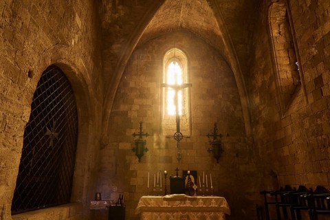 Chancel of the monastery church, interior of a church with illuminated altar and Gothic window,