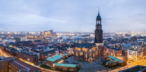 Panorama aerial view of St. Michael's Church (Michel) at blue hour with harbour and Elbe