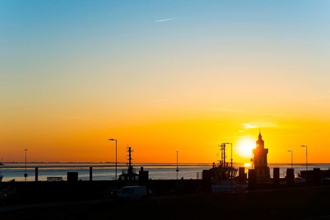 Pingelturm, historic lighthouse in the harbour, atmospheric, golden, beautiful sunset, silhouette