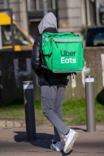 Food, food delivery service Uber Eats, delivery driver, on foot in Antwerp, Flanders, Belgium,
