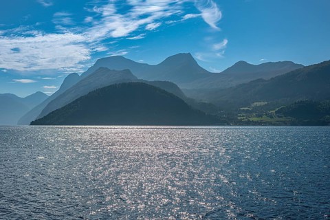 Norddalsfjord, view from the Linge ferry terminal to the south, backlit mountain ranges, near