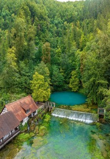 Blautopf Blaubeuren with industrial monument Hammerschmiede, source of the little river Blau in a