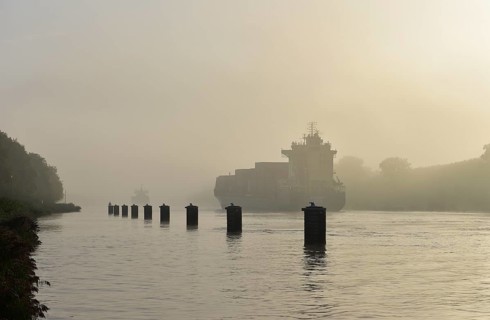 Container ship sailing in fog in the Kiel Canal, Kiel Canal, Schleswig-Holstein, Germany, Europe