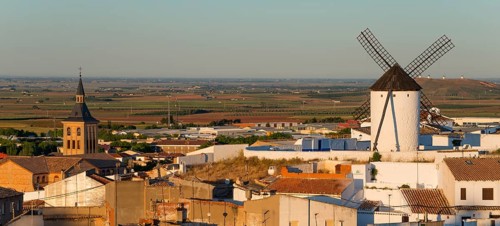View of a windmill and a village with a church in the morning light, Campo de Criptana, Ciudad Real