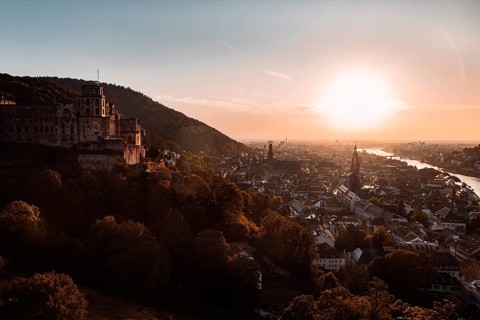 View of the city of Heidelberg with a castle on the hill and a river at sunset, Heidelberg,